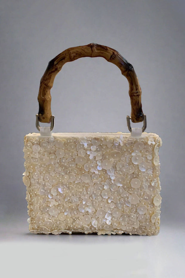 Ivory Beaded Bag with Bamboo Handle available at Mildred Hoit in Palm Beach.