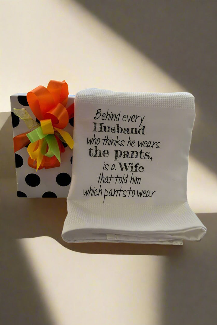 'Behind Every Husband..." Dish Towel wrapped gift available at Mildred Hoit in Palm Beach.