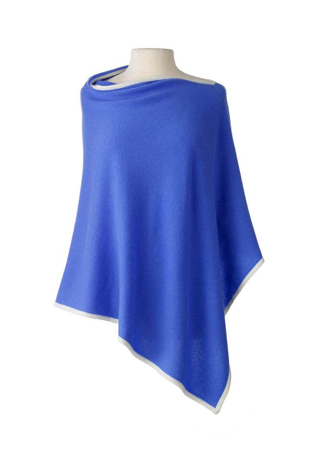 Cashmere Poncho in Cornflower and Ecru available at Mildred Hoit in Palm Beach.