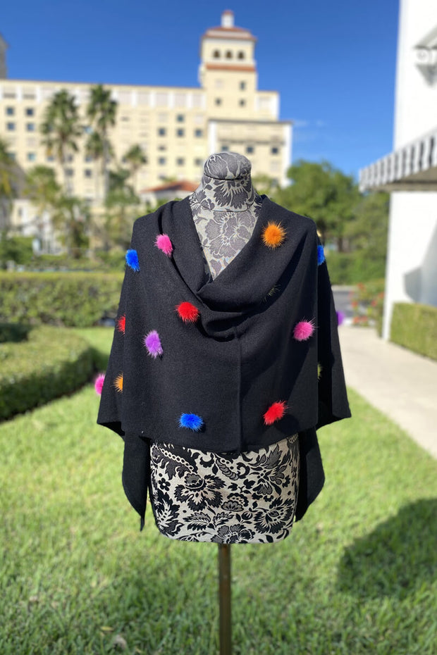 Black Poncho with Multi-Color Pom Detail available at Mildred Hoit in Palm Beach.