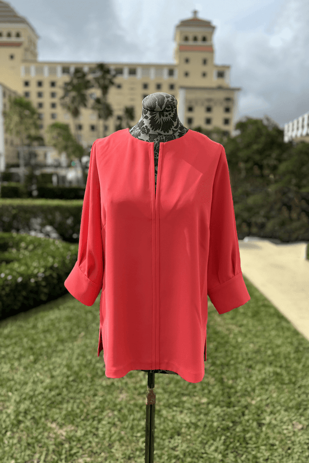 Emmelle 3/4 Sleeve Luxurious Crepe V-Neck Tunic in Coral available at Mildred Hoit in Palm Beach.