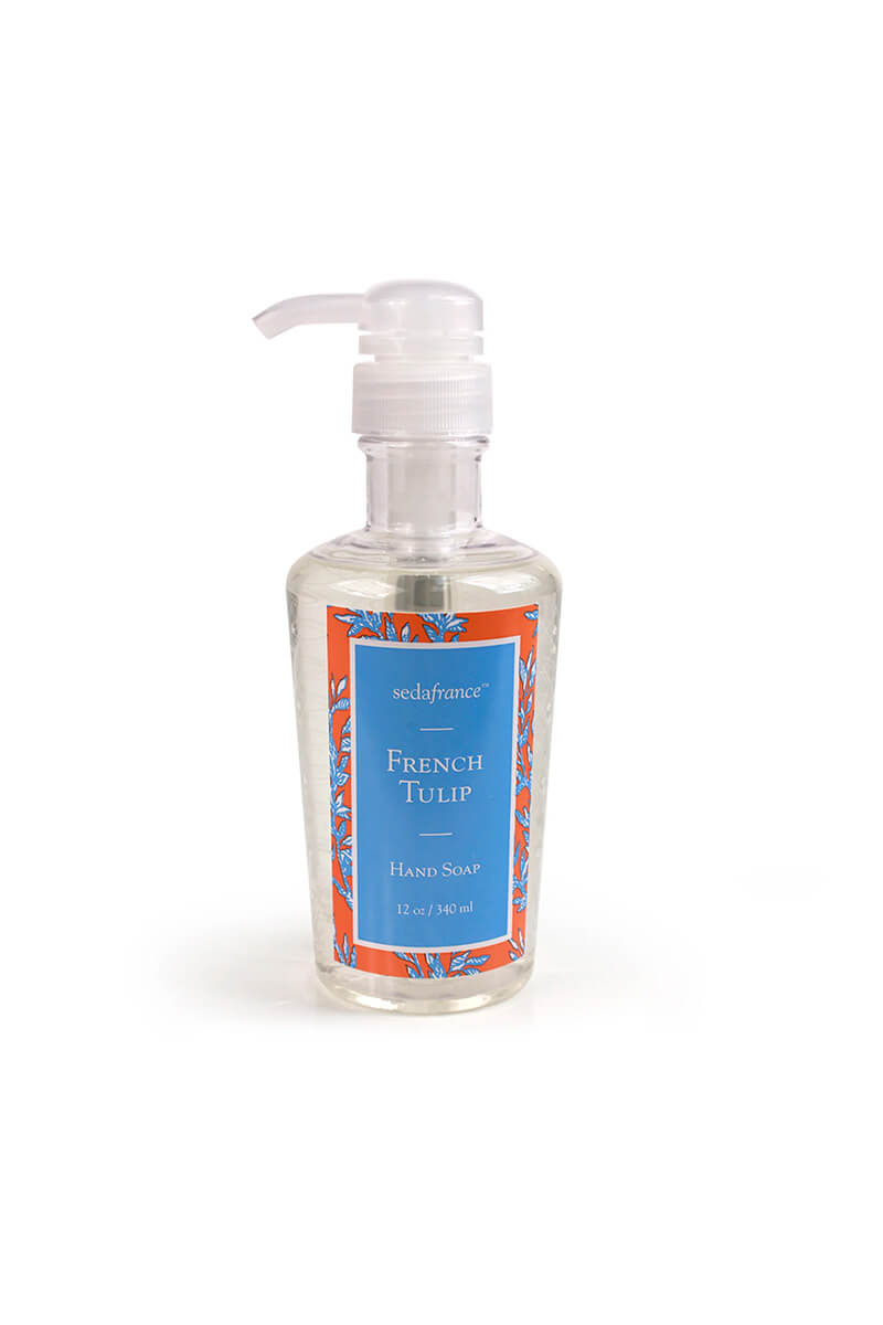 A bottle of SedaFrance French Tulip hand soap with a clear pump dispenser, featuring a blue label with orange and white floral patterns, on a white background.