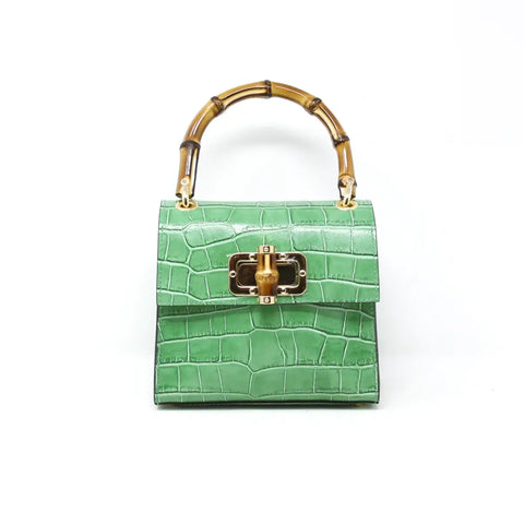 Small Leather Handbag with Bamboo Handle in Green available at Mildred Hoit in Palm Beach.