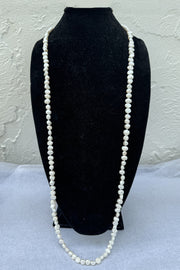 Kenneth Jay Lane 48" White Pearl Necklace with Gold Clasp available at Mildred Hoit in Palm Beach.
