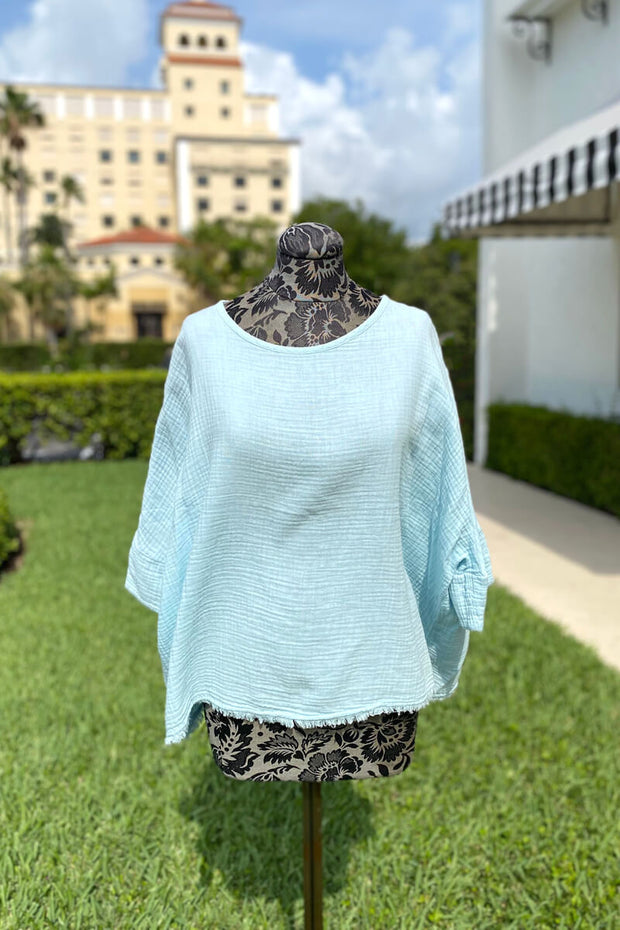 Pure Amici Sky Fringe Poncho available at Mildred Hoit in Palm Beach.
