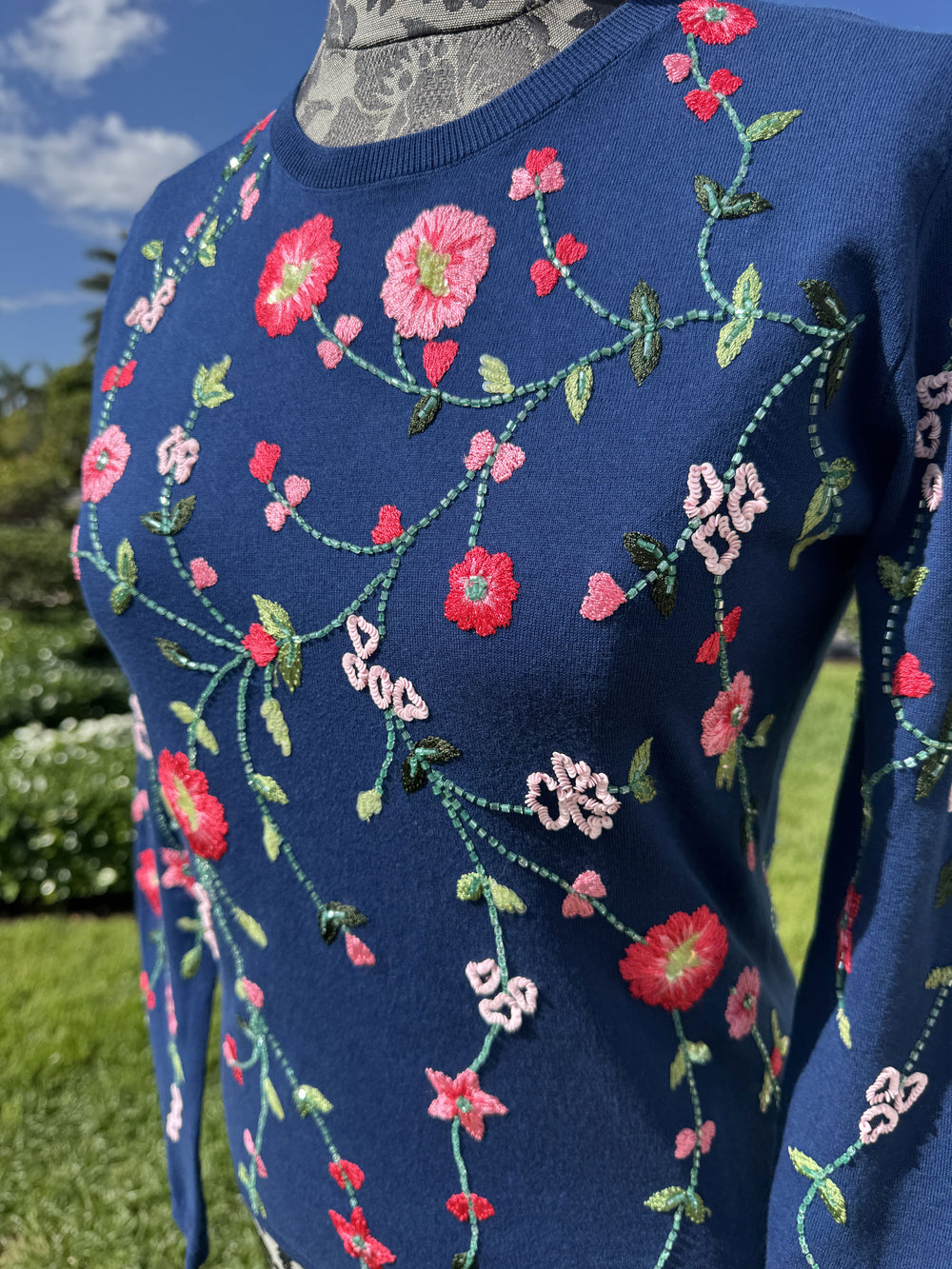 Up Close View of Richard Grand Navy Cotton Sweater with Pink Floral Detail.