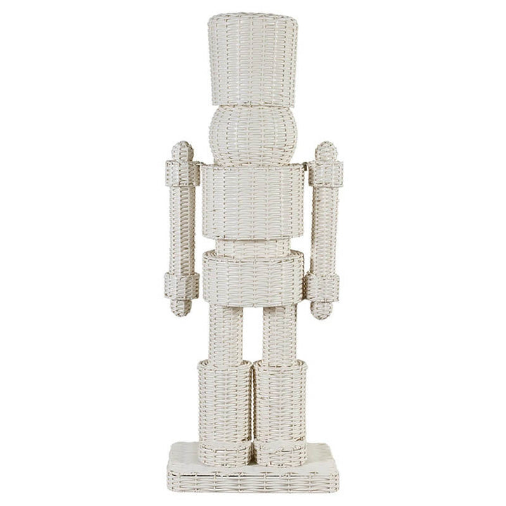An off-white woven nutcracker figurine with a textured wicker-like finish, standing on a square base against a plain white background.