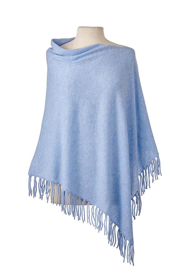 Fringed Poncho in Sky available at Mildred Hoit in Palm Beach.