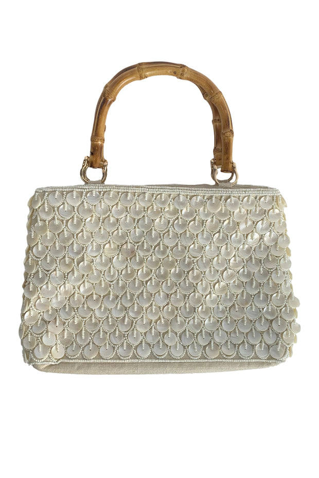 Ivory Shell Bag with Bamboo Handles available at Mildred Hoit in Palm Beach.